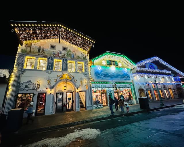 Bavarian-style buildings in downtown Leavenworth, Washington, glowing with holiday lights on a winter night