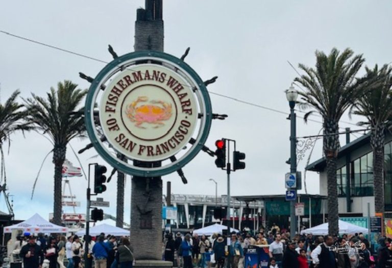 Fisherman’s Wharf sign in San Francisco with palm trees and crowds, showing the best time to visit San Francisco