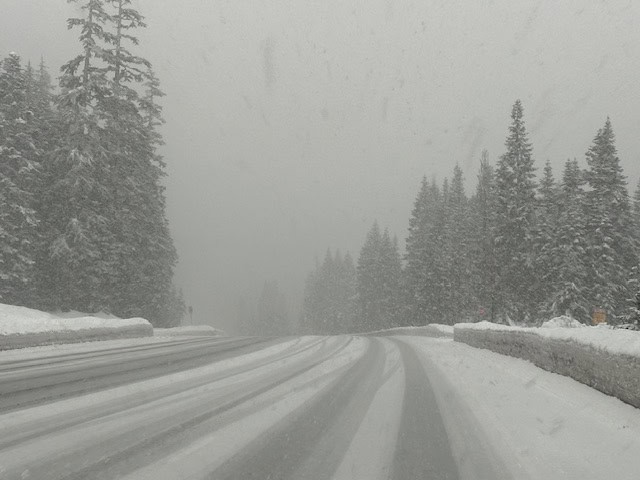 Snow-covered Highway 2 winding through the Cascade Mountains toward Leavenworth, Washington