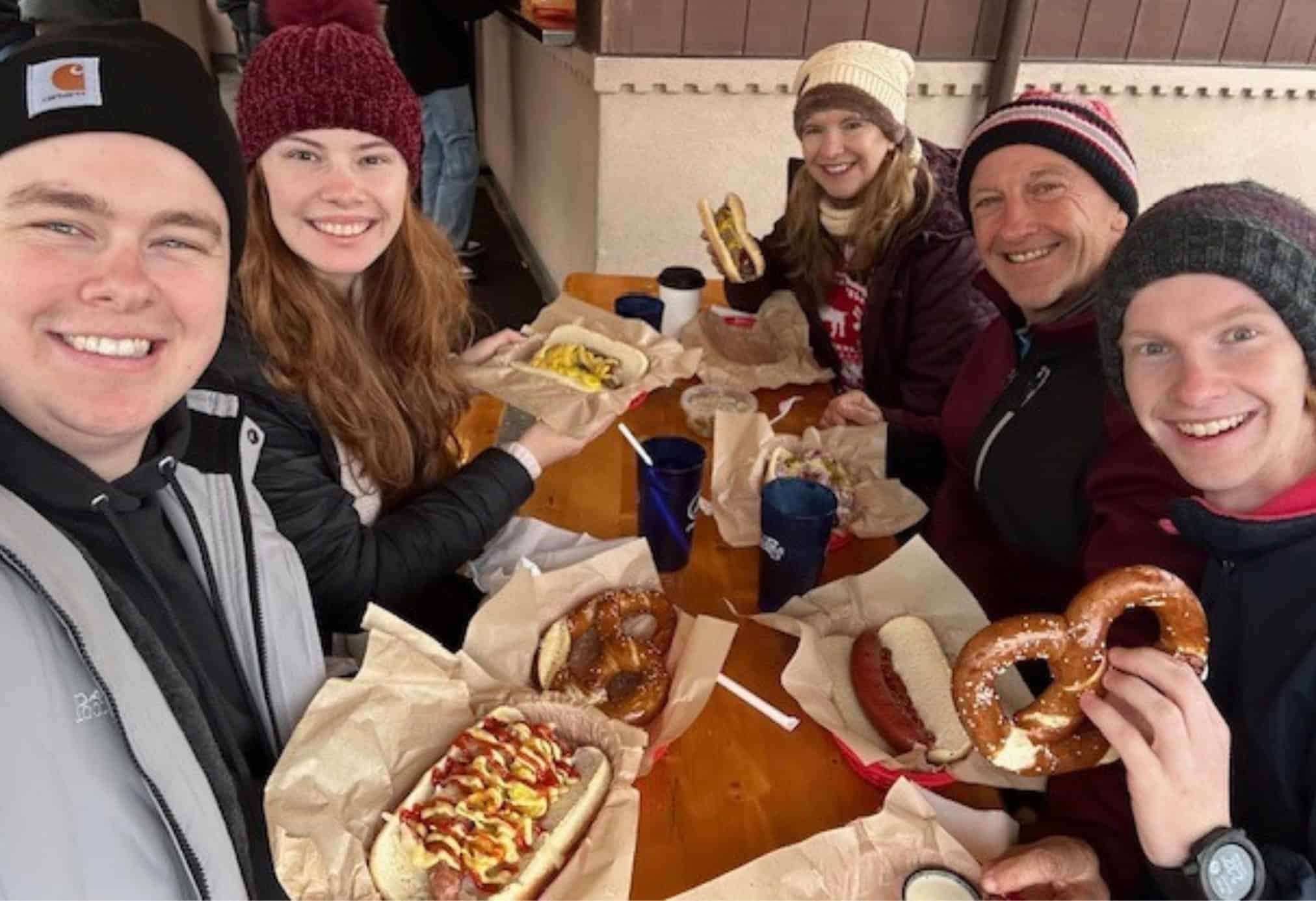 People enjoying sausages and pretzels at the outdoor Sausage Garten in Leavenworth, Washington