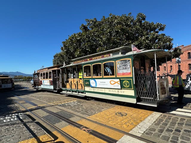 Historic San Francisco cable car on the Powell & Hyde line under blue skies — a must-do experience during 2 days in San Francisco