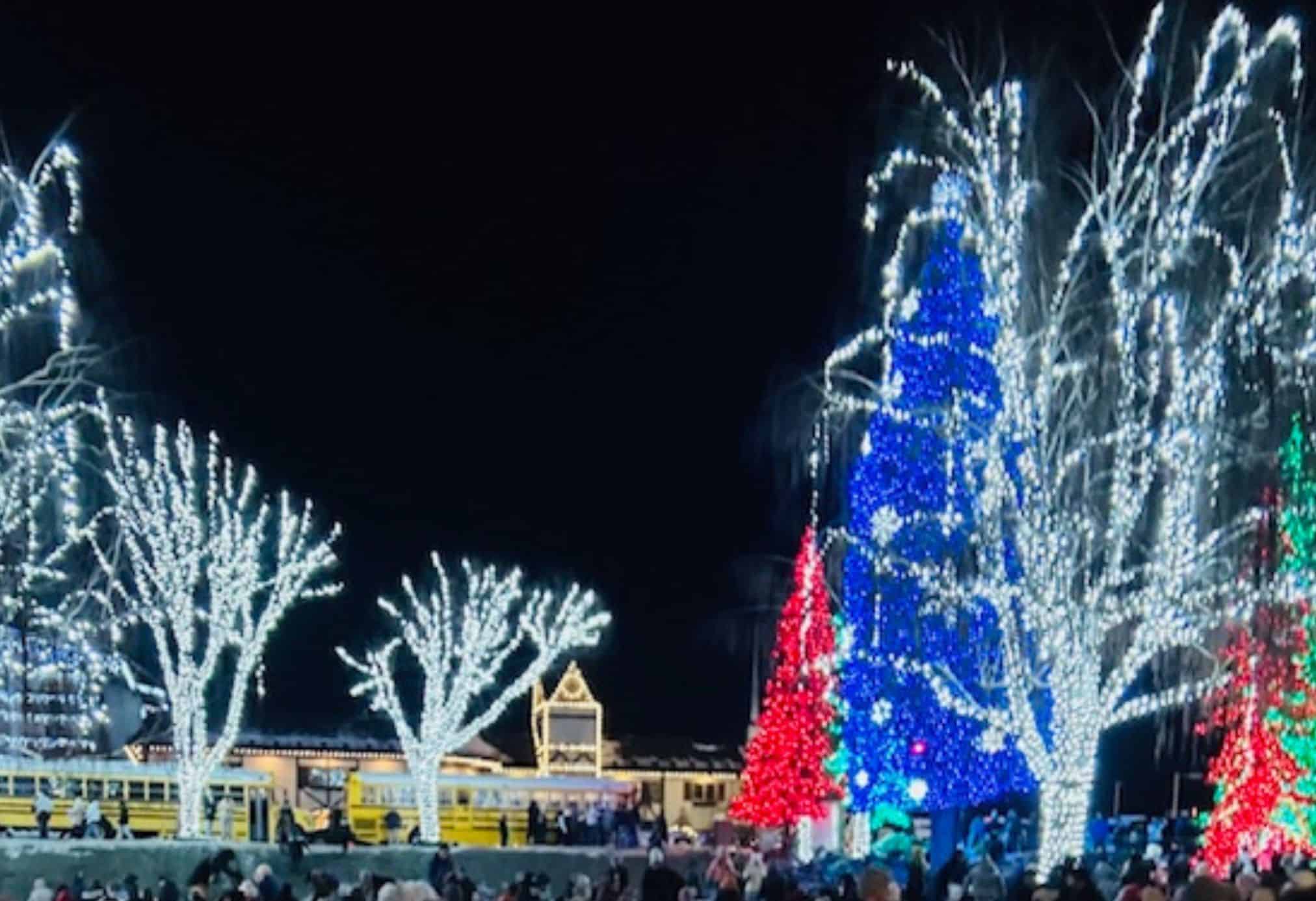Festive holiday lights in downtown Leavenworth, Washington with glowing trees and colorful Christmas displays during winter.