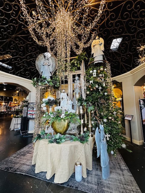 Elegant Christmas display at Pottery World in Sacramento featuring angels, nativity décor, sparkling lights, and festive holiday greenery