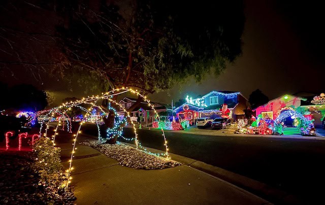 Twinwood Loop neighborhood in Sacramento decorated with festive Christmas lights and illuminated arches at night