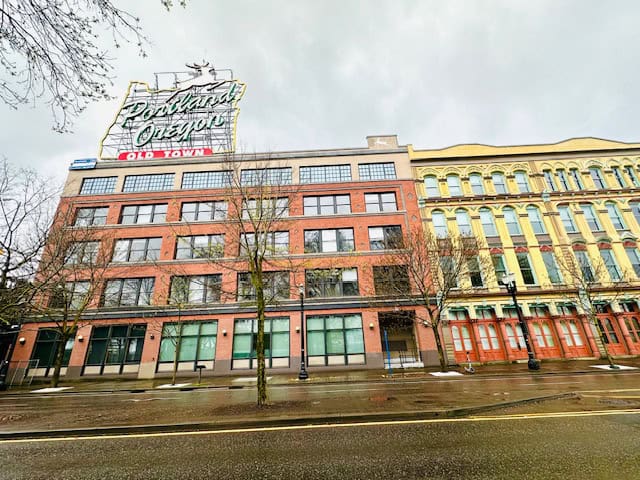 Historic Old Town Portland buildings with the iconic Portland Oregon sign on a rainy day, featured in a 2-day Portland itinerary