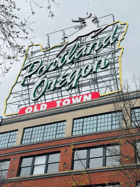 Iconic Portland Oregon White Stag sign reading “Portland Oregon Old Town” on building in downtown Portland near the waterfront
