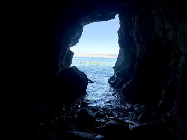 View from inside Sunny Jim’s Sea Cave overlooking the Pacific Ocean and kayakers in La Jolla California