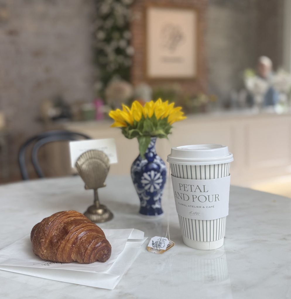 Fresh croissant and hot tea on a café table at Petal Pour in downtown Chattanooga, a cozy stop on a Chattanooga 2 Day Itinerary