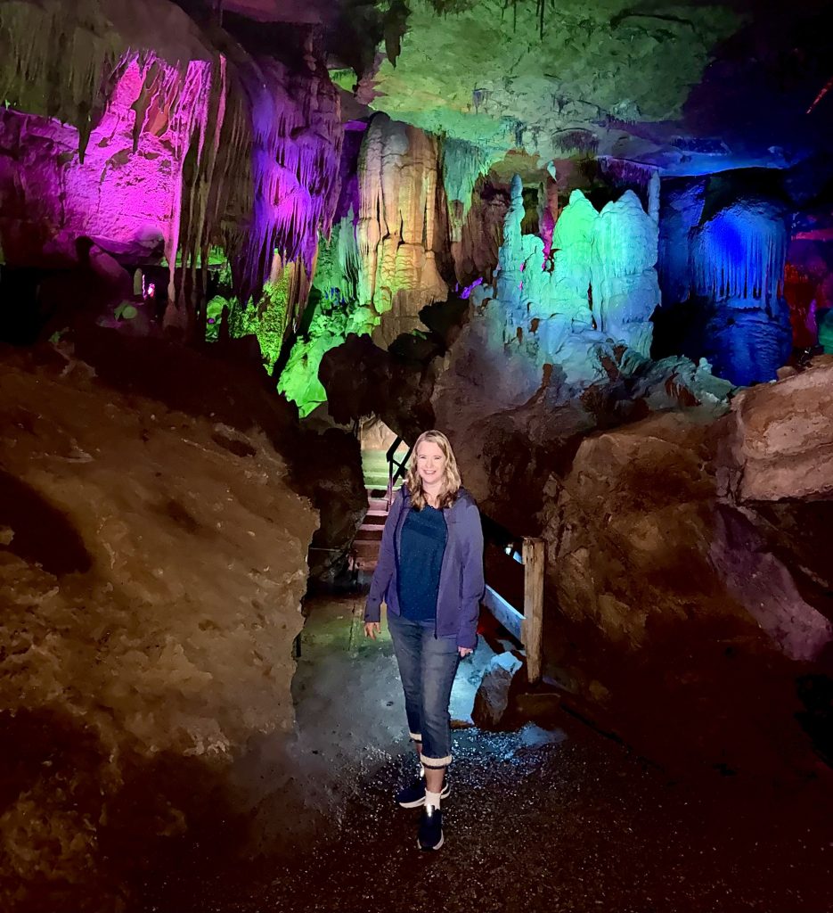 Traveler exploring the colorful rock formations inside Raccoon Mountain Caverns in Chattanooga, Tennessee, during a Chattanooga 2 Day Itinerary