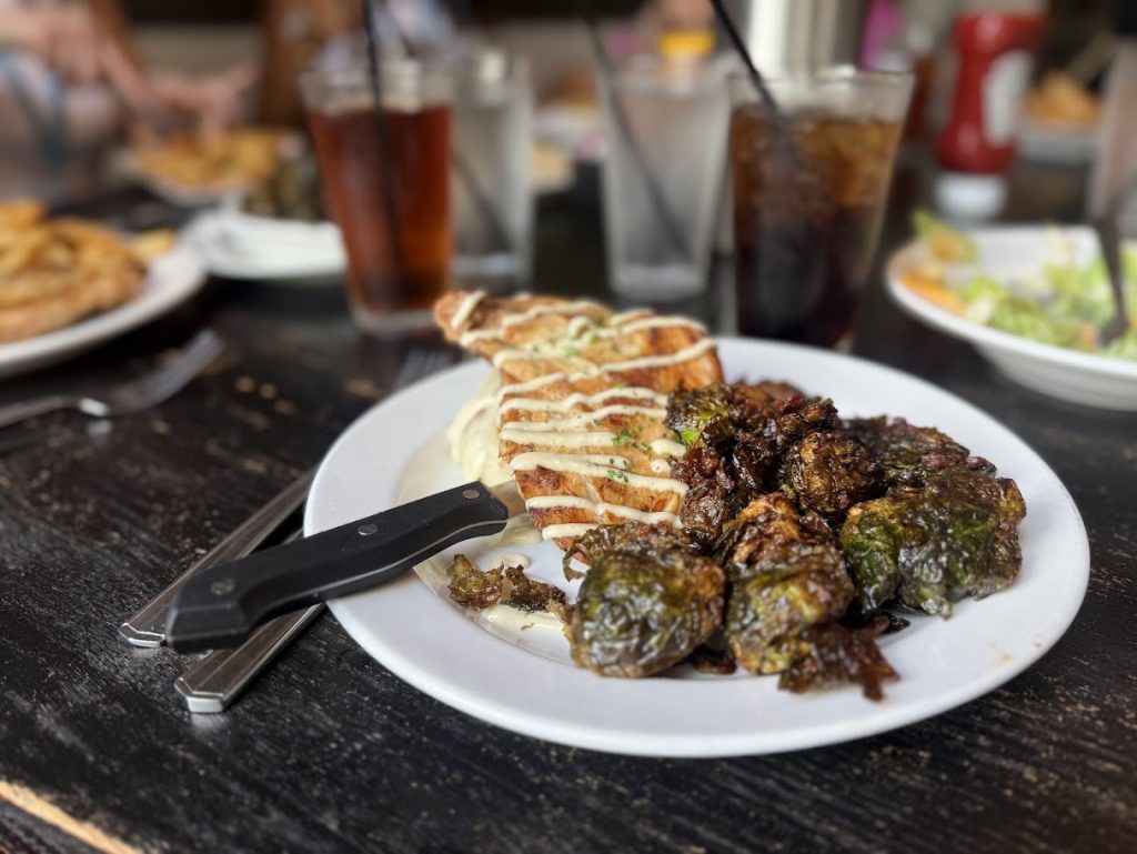 Southern fried chicken served with roasted Brussels sprouts and creamy mashed potatoes at Feed Co. Table & Tavern in Chattanooga, Tennessee