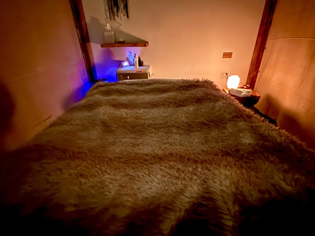Massage room at The NOW Massage in El Dorado Hills with a cozy treatment table and warm ambient lighting