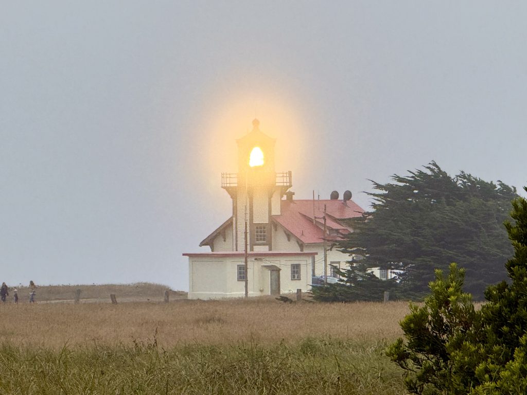 Point Cabrillo Lighthouse glowing through the coastal fog during a mother daughter weekend in Mendocino, California