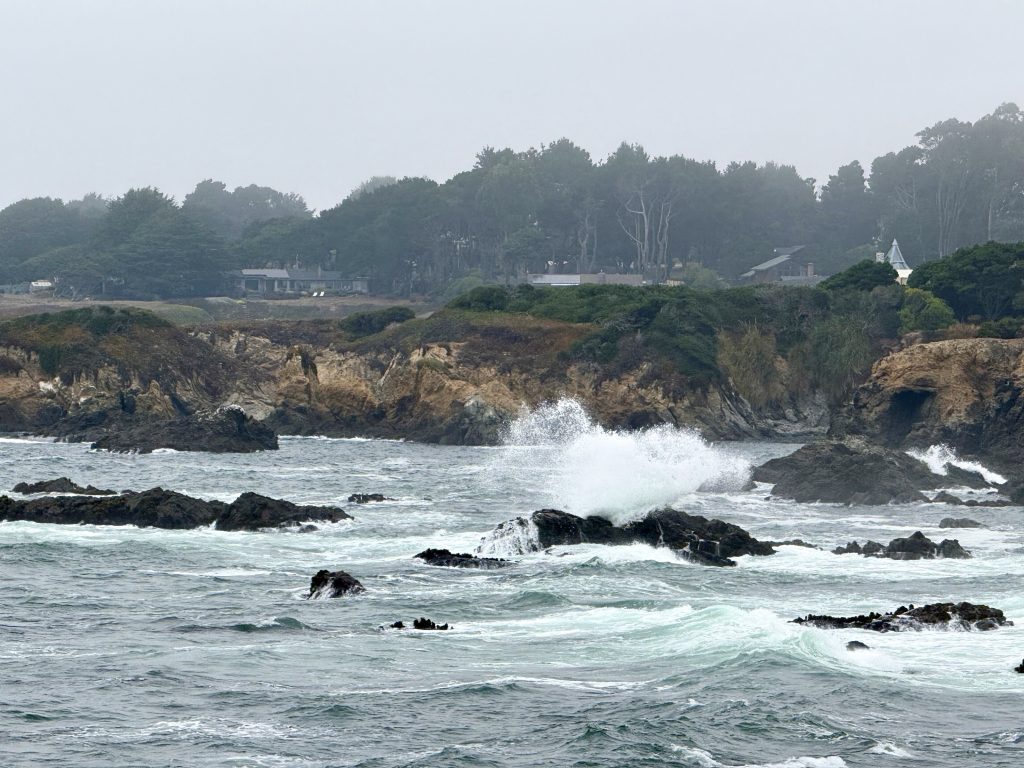 Waves crashing against rocky cliffs on the Mendocino Coast during a girls weekend in Mendocino, California