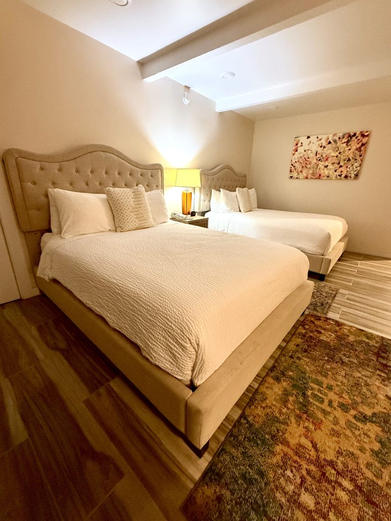 Hotel room with two beds at Seafoam Lodge during a girls weekend in Mendocino, California