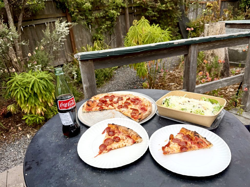 Pepperoni pizza, Caesar salad, and Coca-Cola at The Brickery during a girls weekend in Mendocino, California